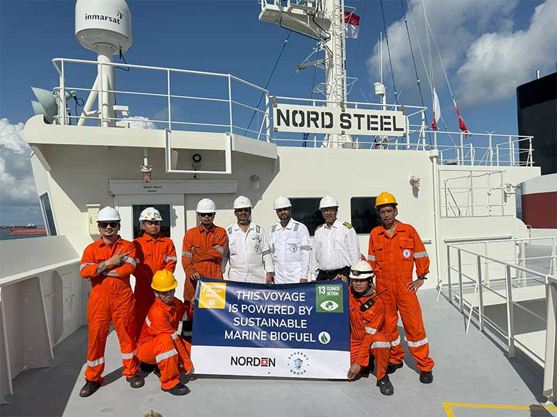 Entire crew of Nord steel vessel standing for a photo after completing the voyage powered by Sustainable Marine Fuel.