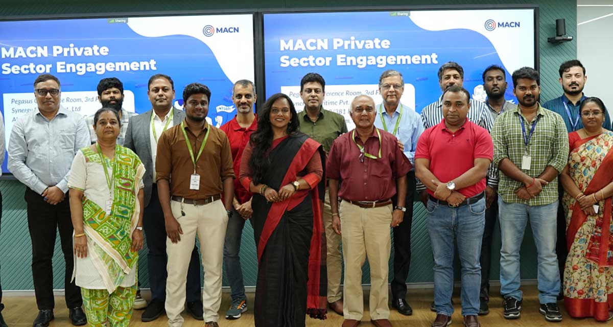 Large group photo of MACN Private Sector Engagement attendees standing in front of the event backdrop, showcasing diverse professionals in formal wear