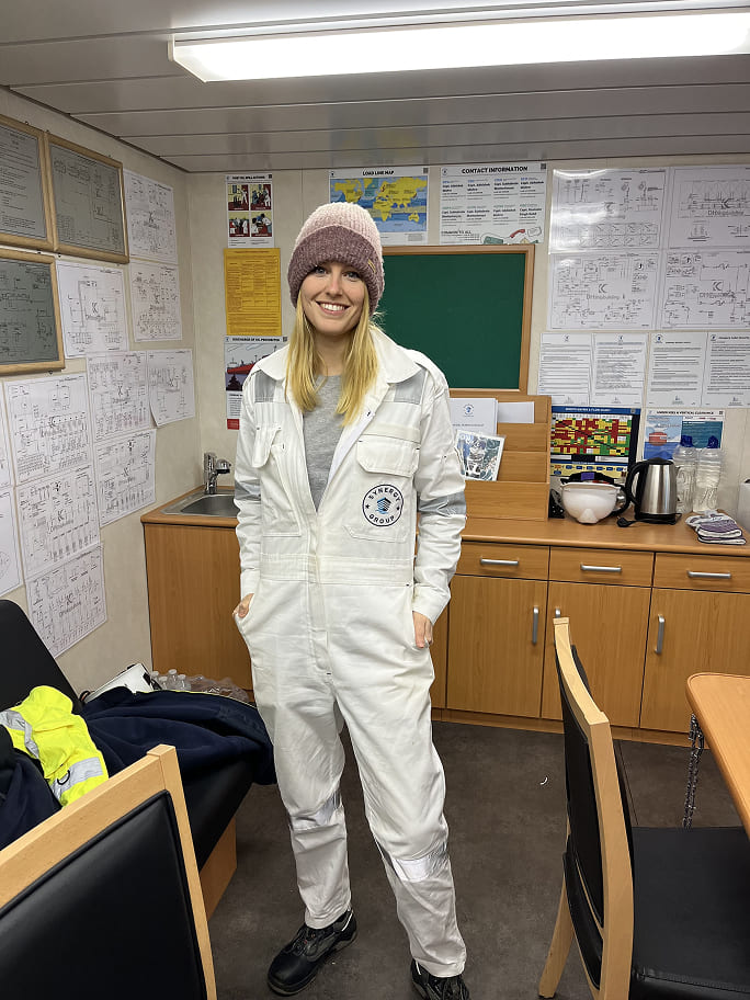 Eva Bergant wearing Synergy Marine Group coveralls on board, showcasing her role in ship management and maritime operations.