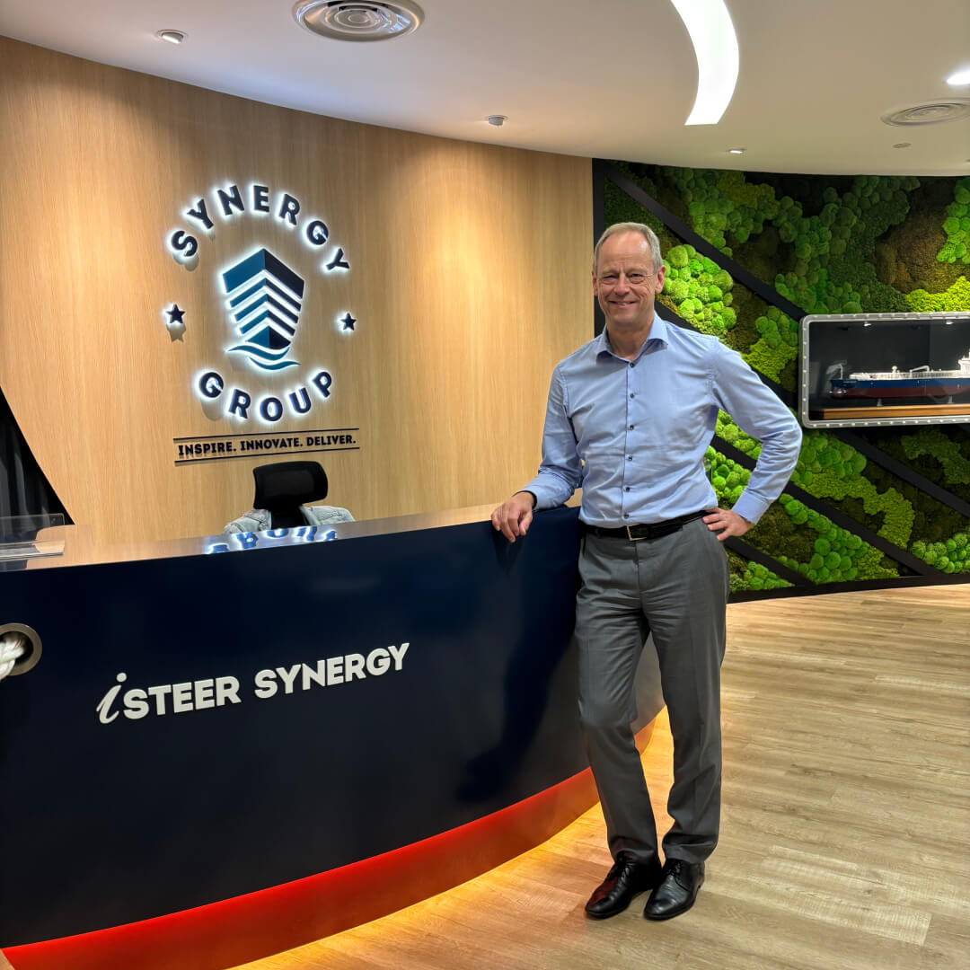 esper Kristensen, Group CEO of Synergy Marine Group, at the Synergy office reception with company logo