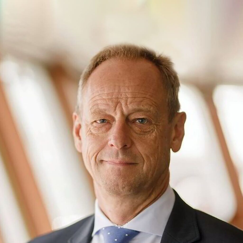 Jesper Kristensen, Group CEO of Synergy Marine Group, photographed in front of a wall featuring the company logo.