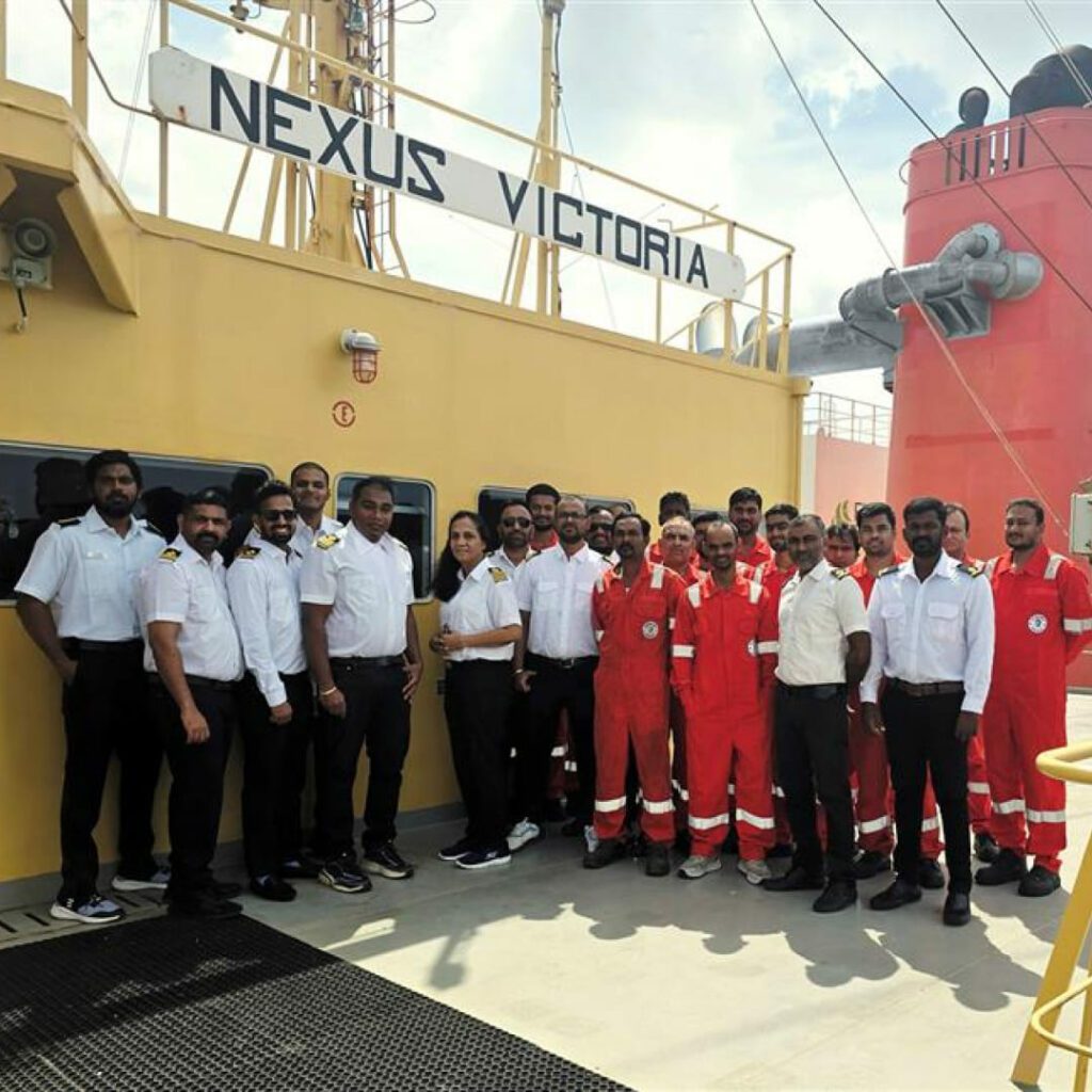 Crew of NEXUS VICTORIA on deck, celebrating recognition for leadership, safe operations, and maritime excellence.