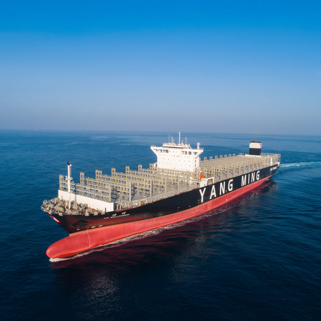 Aerial view of the Yang Ming container ship YM Willpower navigating the open blue sea